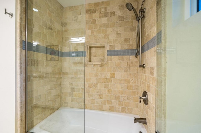 bathroom featuring shower / bath combination with glass door