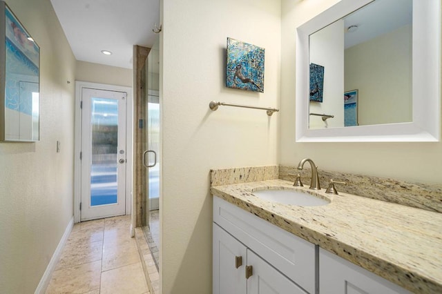 bathroom with vanity, tile patterned flooring, and walk in shower