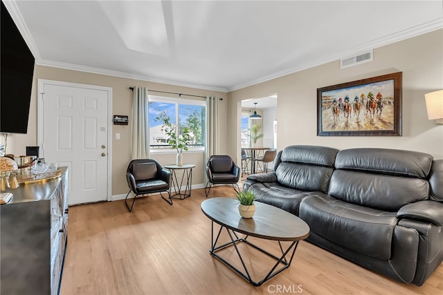 living room featuring ornamental molding and light wood-type flooring