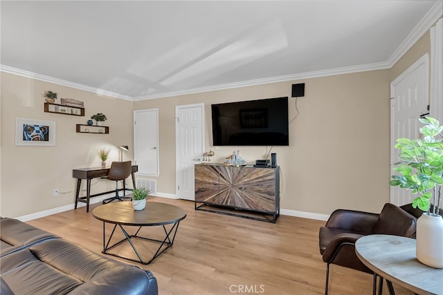 living room featuring crown molding and light hardwood / wood-style floors