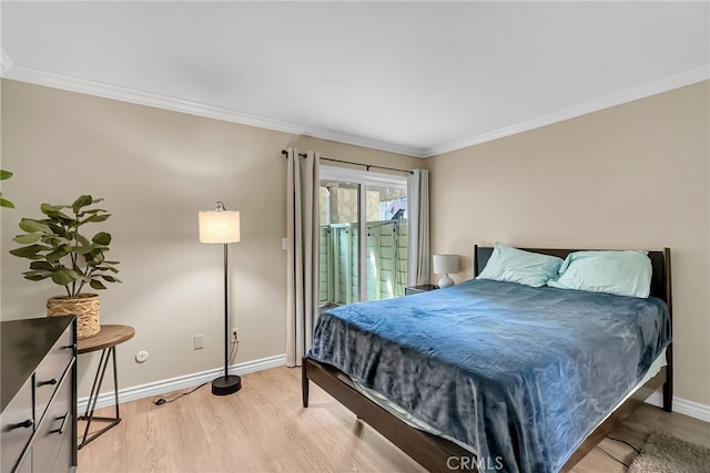 bedroom featuring crown molding, access to exterior, and light hardwood / wood-style floors