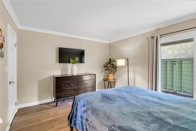 bedroom featuring crown molding and light hardwood / wood-style floors