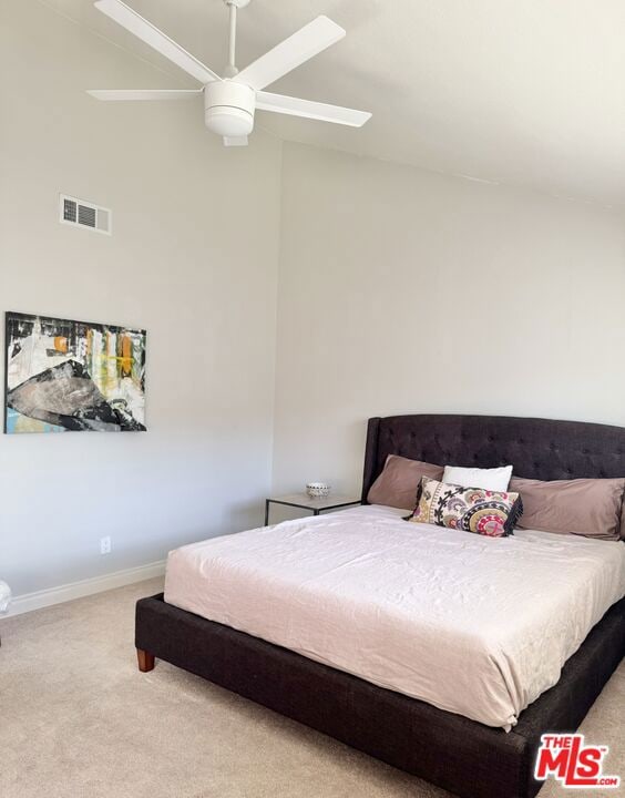 carpeted bedroom featuring lofted ceiling