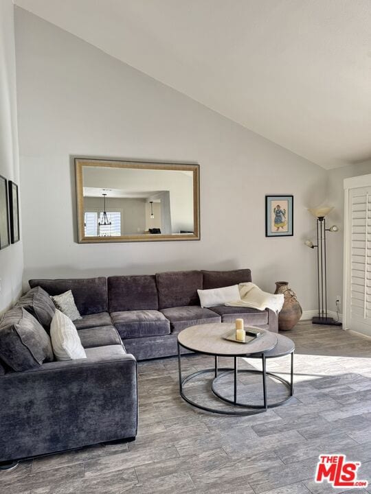 living room featuring hardwood / wood-style flooring and vaulted ceiling