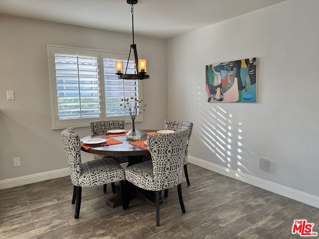 dining room featuring dark wood-type flooring and a chandelier