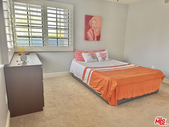 bedroom featuring light colored carpet