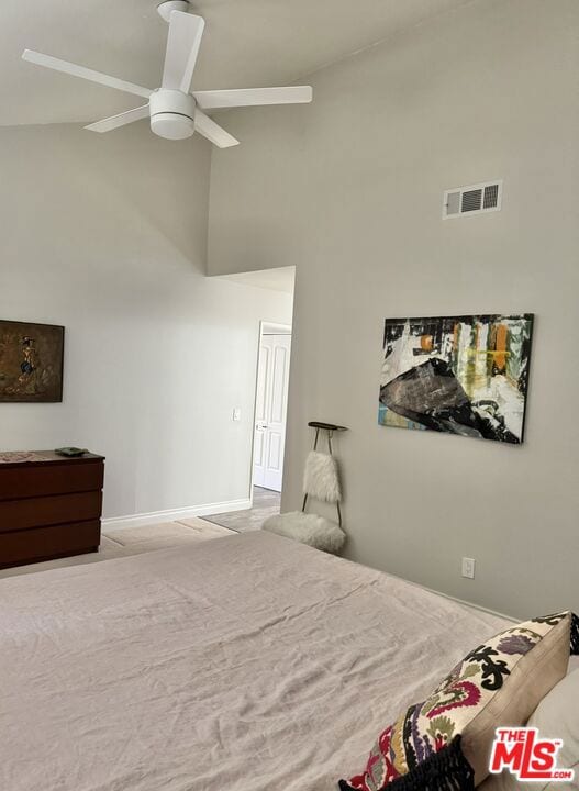 bedroom featuring ceiling fan, light colored carpet, and high vaulted ceiling