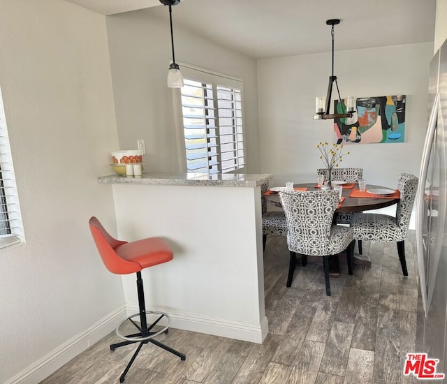 dining area with dark hardwood / wood-style flooring