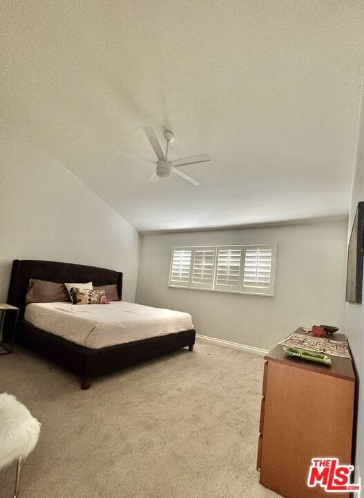 bedroom featuring ceiling fan and light carpet