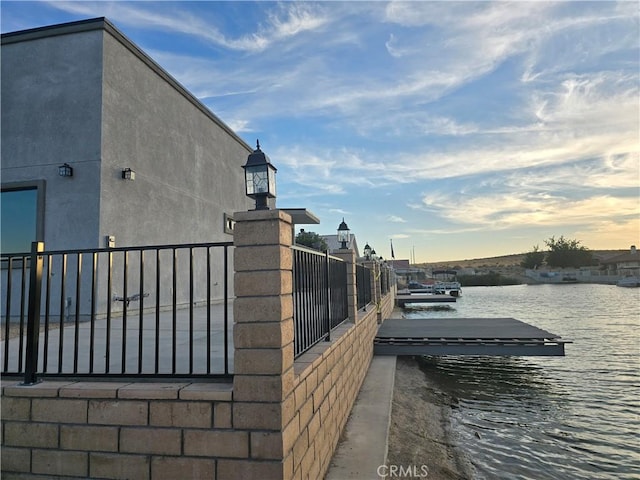 view of home's exterior featuring a water view and a boat dock