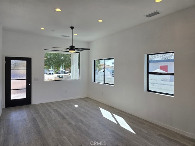 unfurnished room with hardwood / wood-style flooring and ceiling fan