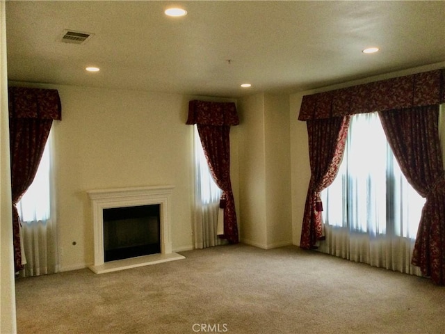 unfurnished living room featuring light carpet