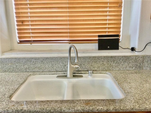 details with light stone counters and a sink