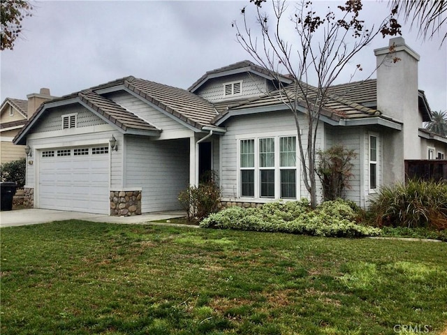 view of front of house featuring an attached garage, a tiled roof, concrete driveway, a chimney, and a front yard