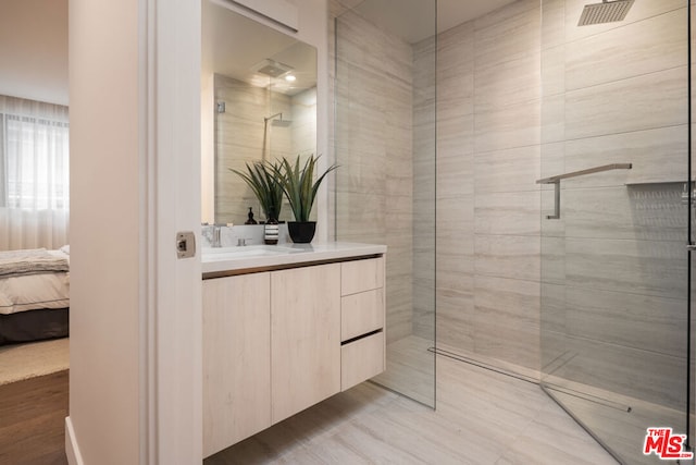 bathroom with vanity and a tile shower