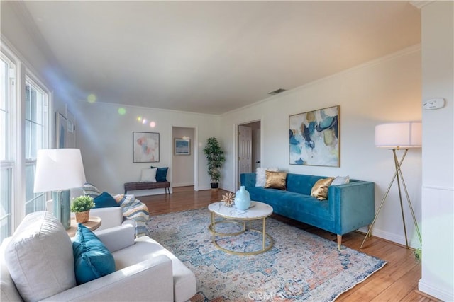 living room featuring crown molding and hardwood / wood-style flooring