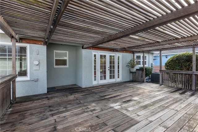 wooden deck with french doors and a pergola