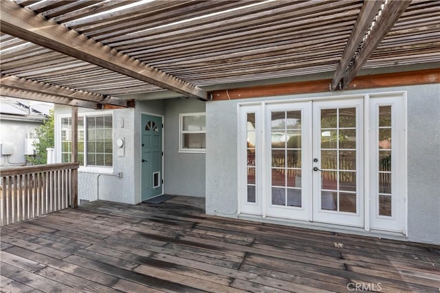 wooden deck featuring french doors and a pergola