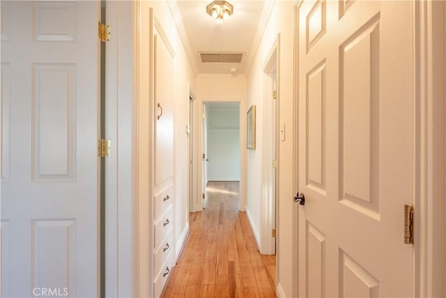 hallway featuring light hardwood / wood-style flooring and ornamental molding