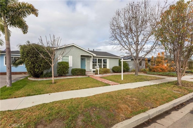 ranch-style house with a front lawn