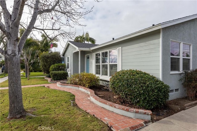 view of property exterior with a yard