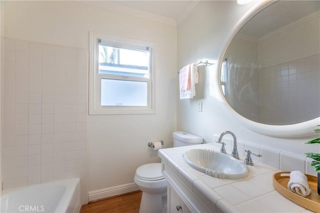 bathroom with ornamental molding, toilet, hardwood / wood-style floors, and vanity