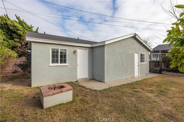 rear view of property featuring a yard