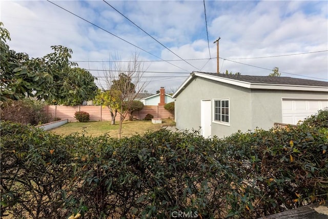 view of side of home with a yard