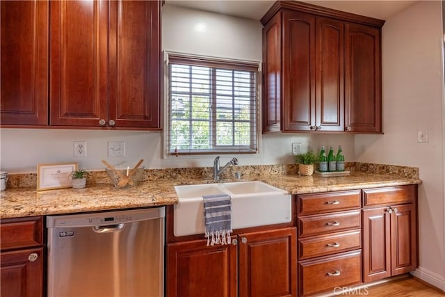 kitchen with sink, light stone countertops, and dishwasher