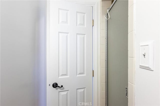 room details featuring a shower with door