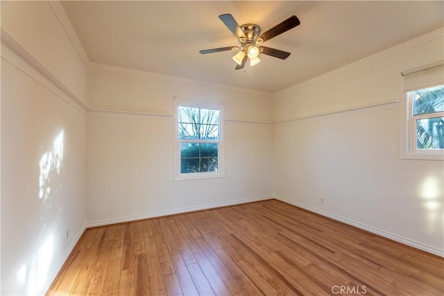 spare room with hardwood / wood-style floors, ornamental molding, and ceiling fan