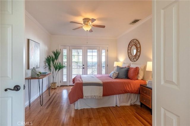 bedroom with french doors, crown molding, light hardwood / wood-style flooring, access to outside, and ceiling fan