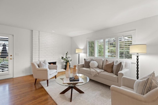 living room with hardwood / wood-style flooring and a fireplace