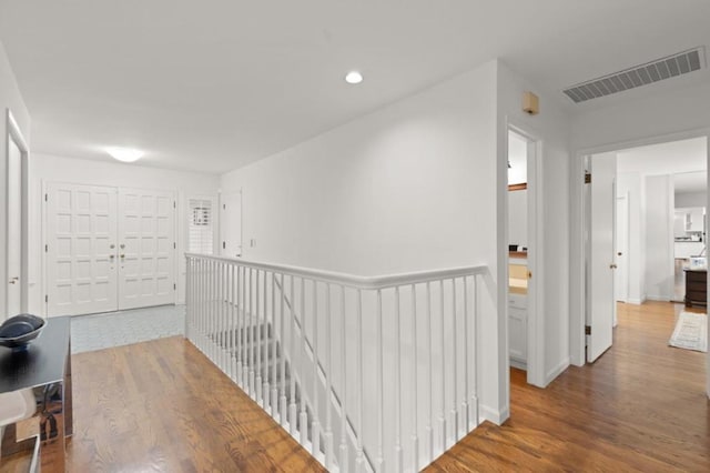 hallway with hardwood / wood-style floors