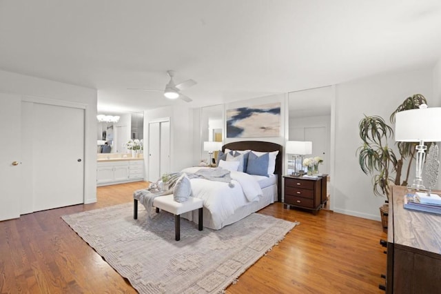 bedroom with connected bathroom, wood-type flooring, and ceiling fan