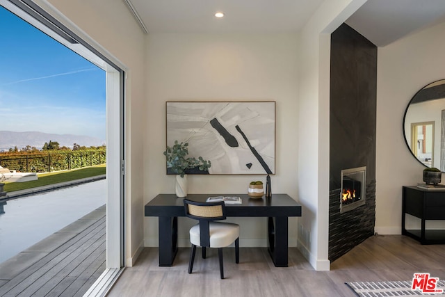 office with a mountain view and light hardwood / wood-style flooring