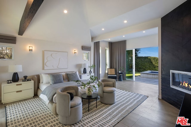 bedroom with a wall mounted AC, access to outside, a large fireplace, and beamed ceiling