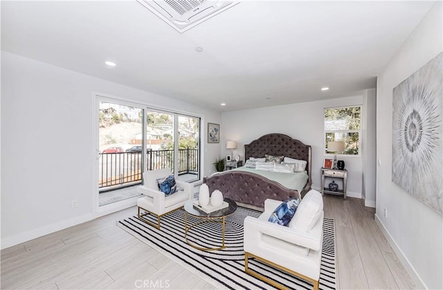 bedroom with access to exterior and light hardwood / wood-style floors