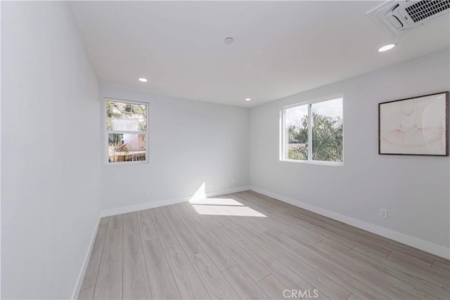 unfurnished room with light hardwood / wood-style floors and a healthy amount of sunlight