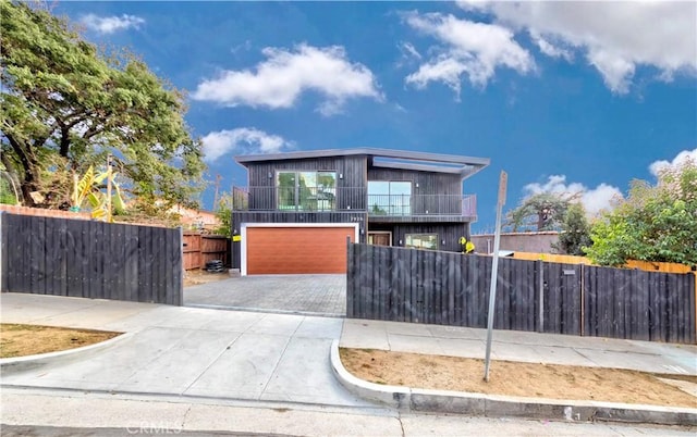 view of front of home featuring a balcony and a garage