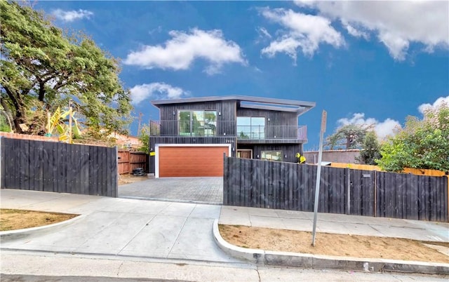 2926 Future St, Los Angeles, CA 90065 - contemporary home with a fenced front yard, driveway, a garage, and a balcony