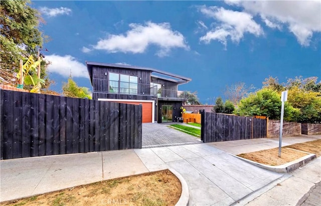 2926 Future St, Los Angeles, CA 90065 - modern home featuring a balcony, a fenced front yard, and driveway