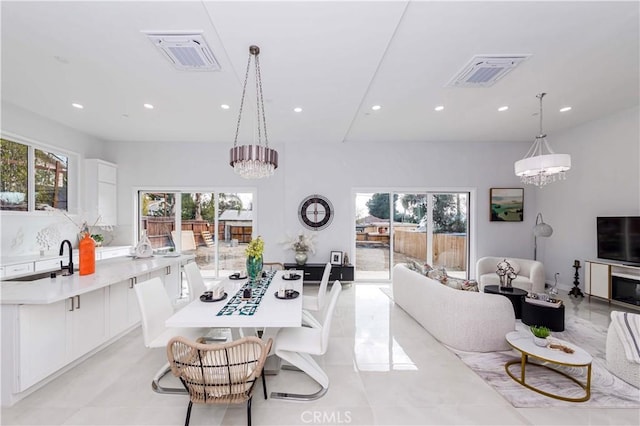 living room with sink and a notable chandelier