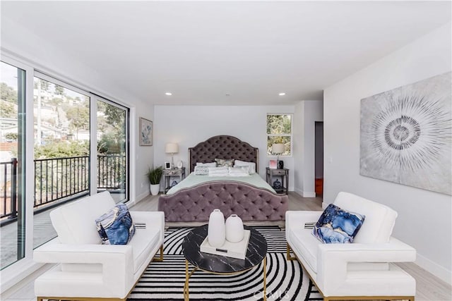 bedroom featuring light hardwood / wood-style flooring and access to outside