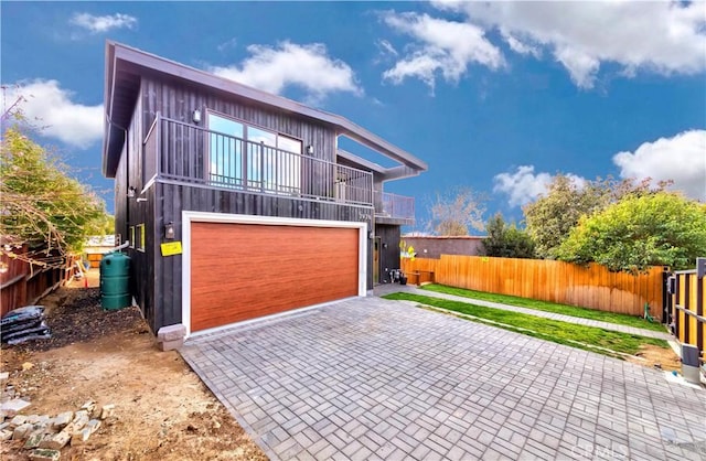 contemporary house featuring a balcony and a garage