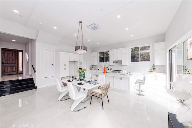 dining area with an inviting chandelier and sink