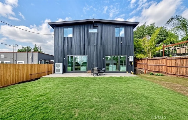 back of house with a patio and a lawn