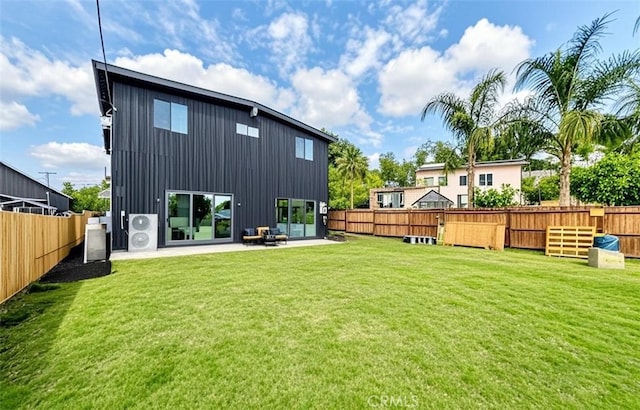 back of house with a patio and a yard