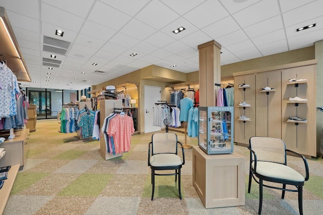 interior space featuring a paneled ceiling and decorative columns