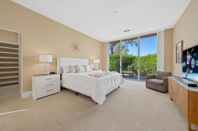 carpeted bedroom featuring expansive windows and access to outside